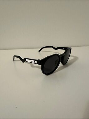 Oakley Black Round Sunglasses with Zigzag Temples and White Logo Accents